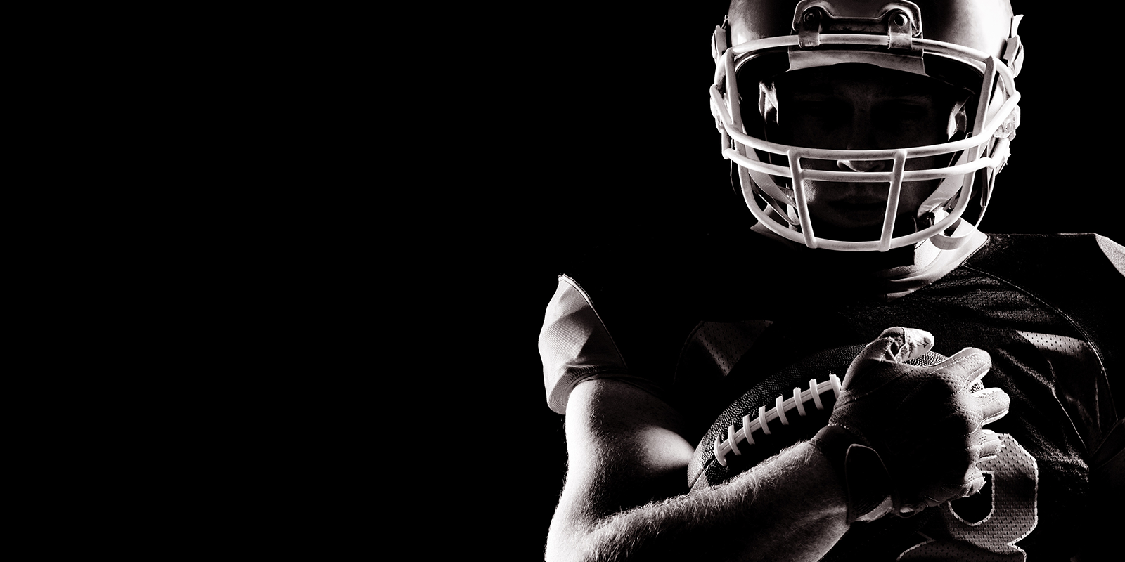 Football player on black background